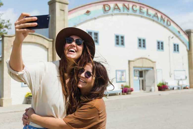 Two women outside danceland taking a selfie Two women outside danceland taking a selfie