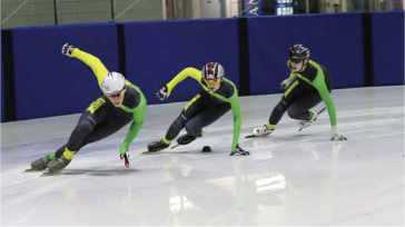 3 speed skaters turning around a corner 3 speed skaters turning around a corner