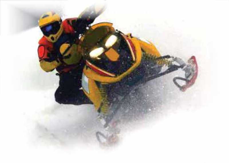 Snowmobiler wearing safety equipment on a snomobile Snowmobiler wearing safety equipment on a snomobile