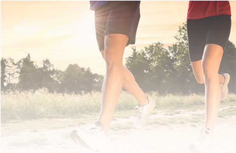 Joggers running in black shorts and a red and blue shirt Joggers running in black shorts and a red and blue shirt