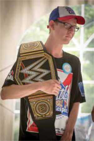 Guy holding champion belt at golf event for childrens wish foundation Guy holding champion belt at golf event for childrens wish foundation