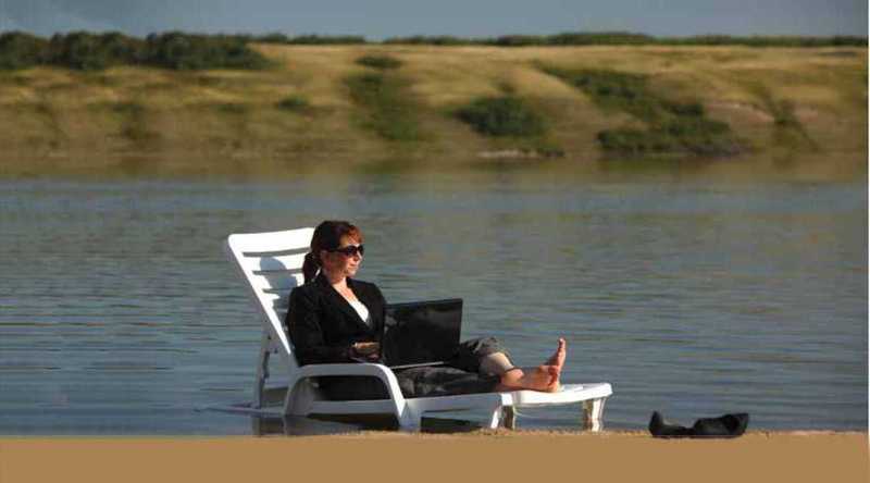 Woman on laptop at Manitou Beach Woman on laptop at Manitou Beach
